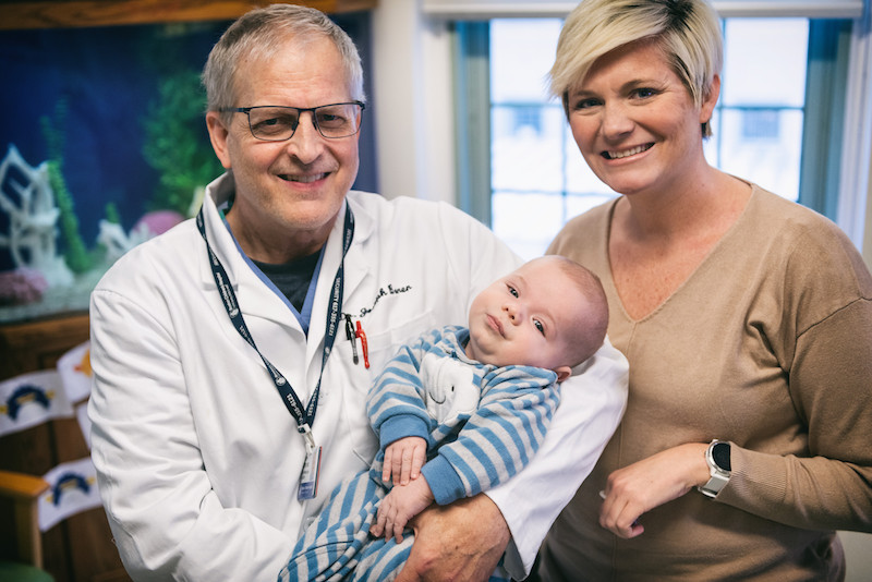 dr borer holds baby with bladder exstrophy as mom looks on