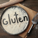 Pie plate covered with flour with gluten spelled out