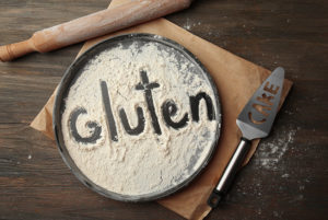 Pie plate covered with flour with gluten spelled out