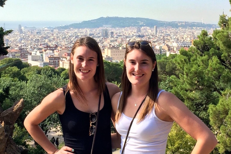 Kristen, who had epilepsy surgery, with her sister in front of a cityscape