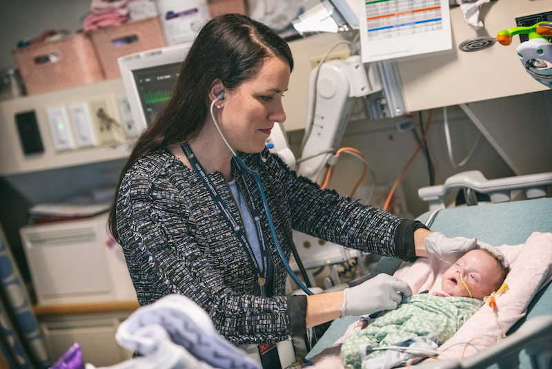 Dr. Kristen Leeman examining a newborn in the NICU