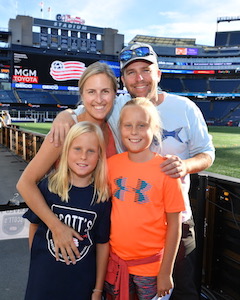 Family together at a stadium on a summer day. 