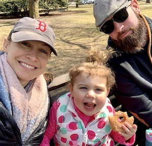 Family on a park bench. Ellery holding a donut.