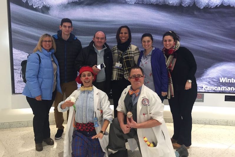Sue-mei Portugues poses with a family and two clowns in the hospital.