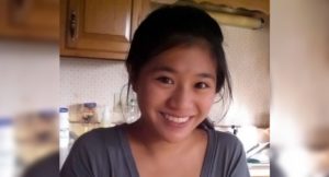 Anna, who had gliomatosis cerebri, smiles in her kitchen