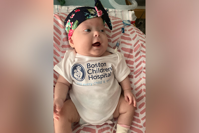 OEIS patient Aubree as a baby, dressed in a Boston Children's onesie