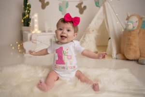 aubree, who has oeis, poses with a pink bow in her hair