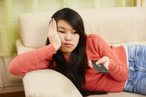bored teen practicing social distancing at home