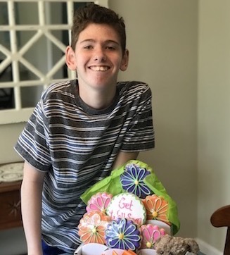 Jared with a basket of gifts after his spinal fusion surgery during COVID-19.