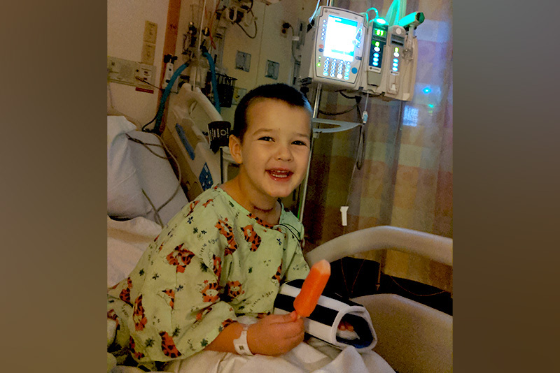 Curtis after thyroidectomy, holding an orange Popsicle