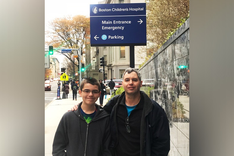 Midaortic syndrome patient Matt and his dad outside Boston Children's.