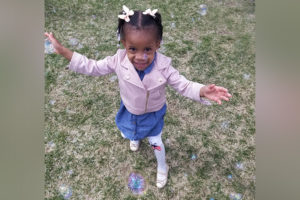 sydney, who has renovascular hypertension, with arms outstretched and in a pink jacket