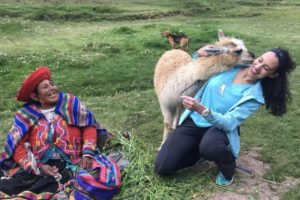 Carla Coutinho of Boston Children's at Martha Eliot gets a greeting from a white llama.