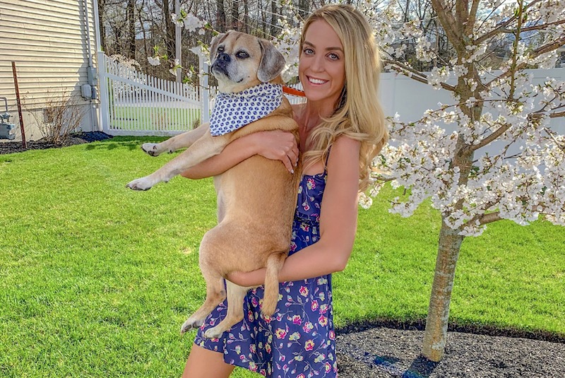Crista, who had Hodgkin’s lymphoma, holds her dog in her backyard