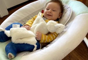 Gabriel with a yellow top and blue casts on both his legs to correct his clubfeet.