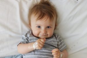 Nathan, who was diagnosed with OMS, smiles from his hospital bed