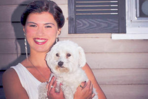 Carolann, who had ear surgery after a concussion, poses with her dog