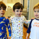 Evan and West, both who have congenital heart disease, pose with Evan's brother in a kitchen