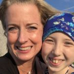 Carly, who had Wilms tumor, and her mom share a hug