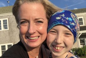 Carly, who had Wilms tumor, and her mom share a hug