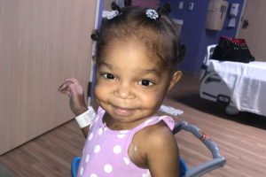 khori, who has congenital enteropathy, is wearing a pink polkadot dress