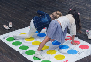 two girls playing the game Twister