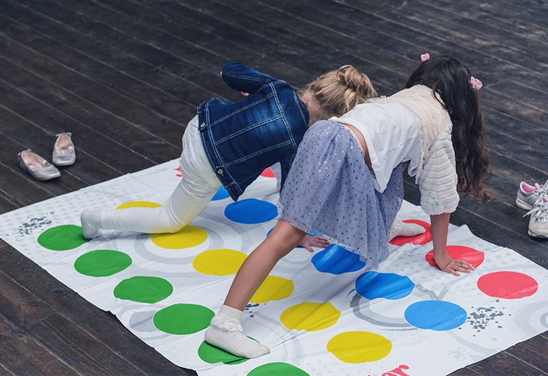 two girls playing the game Twister