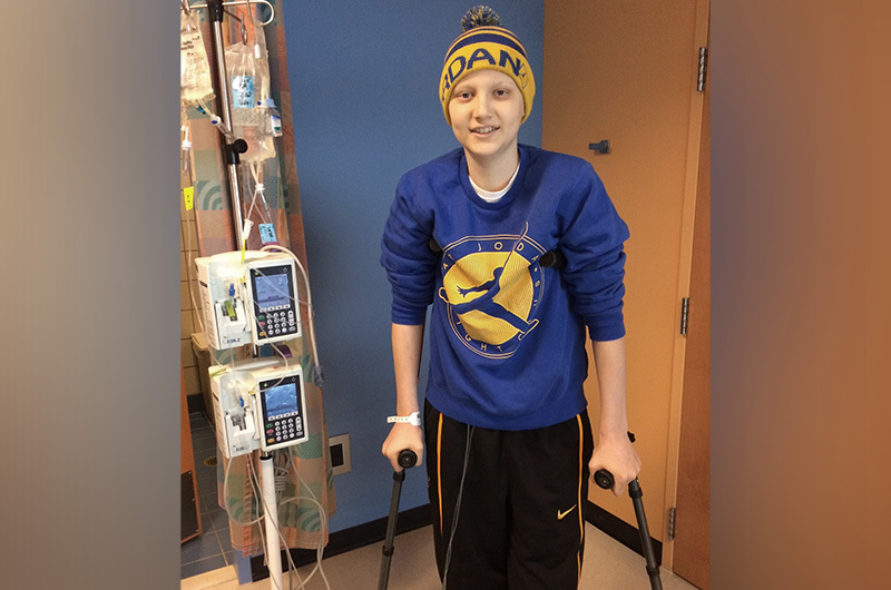 Michael on crutches after his limb-salvage surgery for osteosarcoma. 