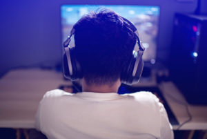 Boy watching a screen wearing headphones