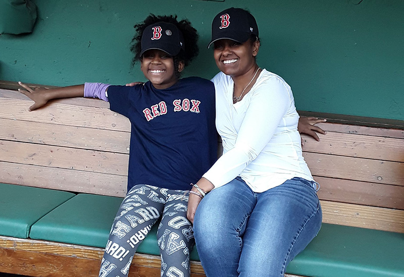 Asada, who had a bone marrow transplant, with her mom, Hadas, sitting together in the Red Sox dugout at Fenway Park