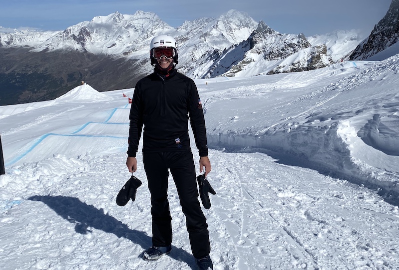 Mikey, who was cleared to return to snowboarding after having COVID-19, stands on a mountain in Switzerland. 