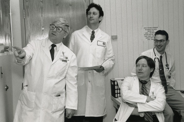 John Herrin, MBBS, FRACP, David Briscoe, MD, William Harmon, MD and Asher Schachter, MD, review films of a patient cared for in the Renal Program, c. 1997