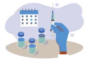 3 vaccine vials with a gloved hand holding syringe