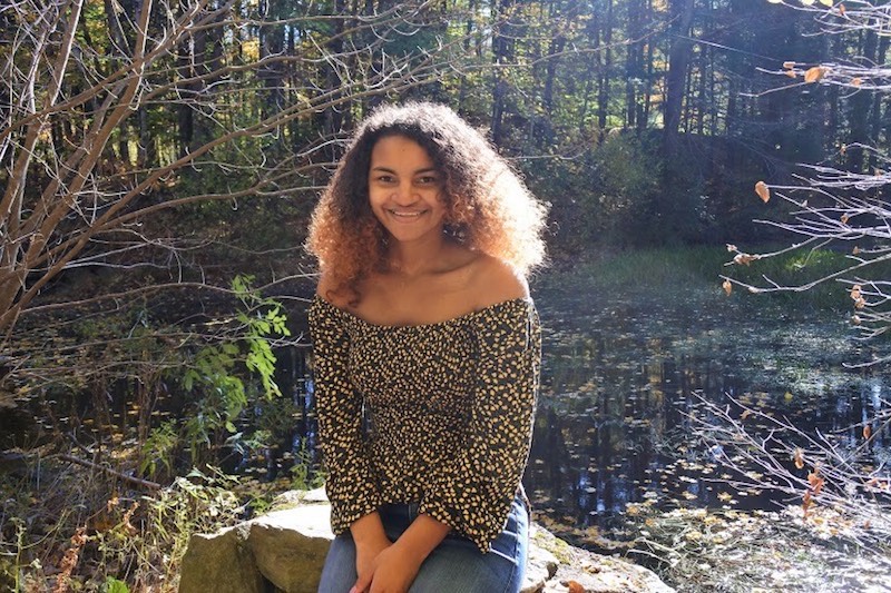 Atiana, who had cardiac arrest and brain injury, poses next to a pond