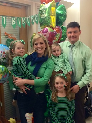 Colin, who was born with infantile scoliosis, with his parents and two sisters on his first birthday. Born on St. Patrick's Day, his favorite color is green. 
