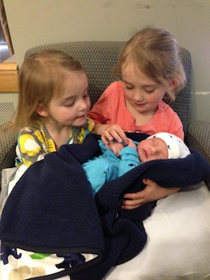 Newborn Colin, who has infantile scoliosis, meets his two older sisters for the first time.