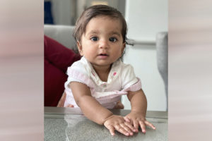 Arya sits at a table after undergoing the minimally invasive Foker process