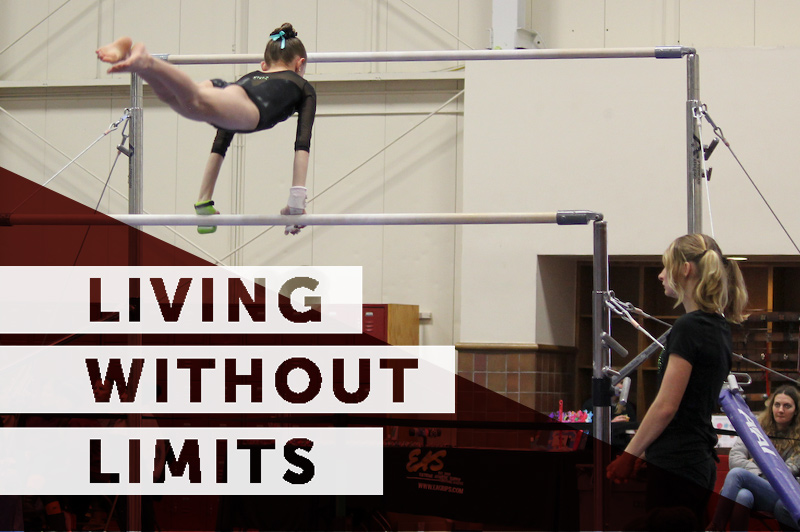 Ashley, who was born with symbrachydactyly, performs a gymnastic feat on the horizontal bars.