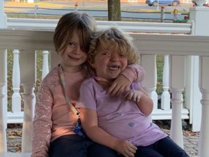 Maisie Hubbard and sister sitting together