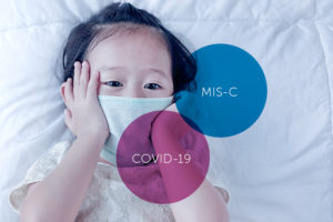 masked child laying down with MISC and COVID19 bubbles