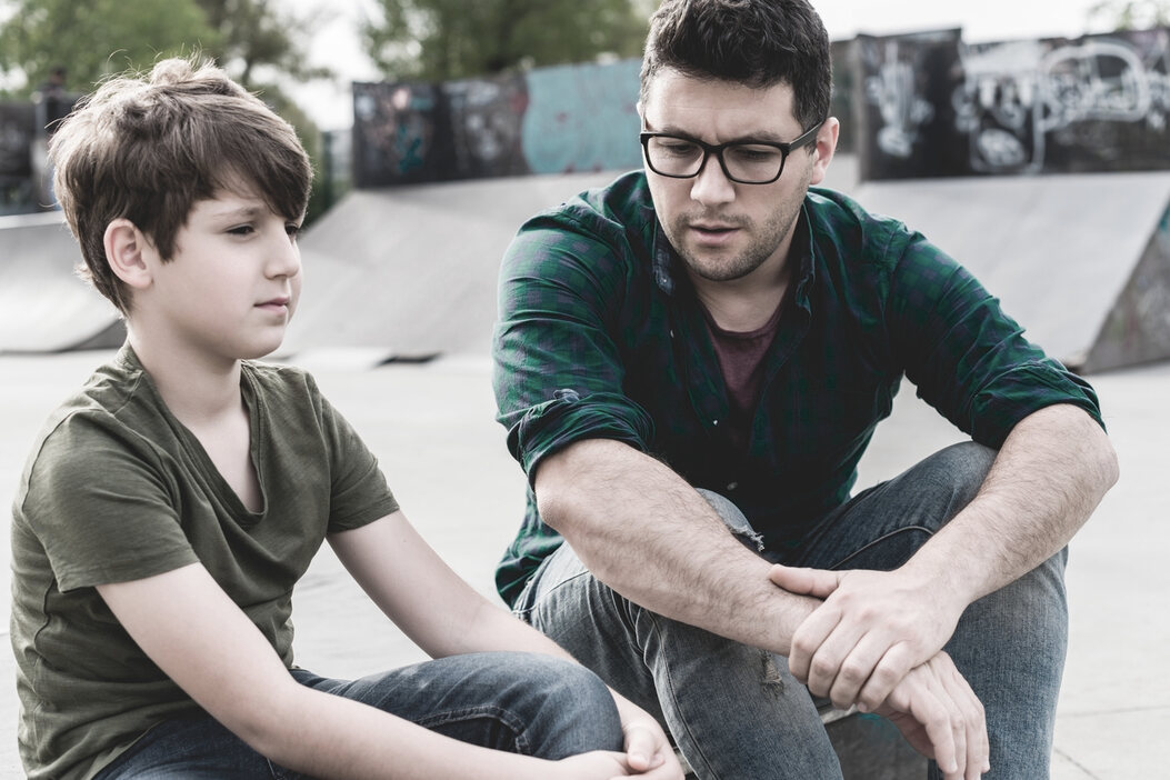father and son discussing behavioral health