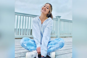 peyton sits cross legged on a porch after surgery for chiari malformation