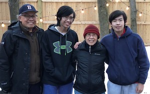 Dr. Ng outside in the winter with her husband and two sons.