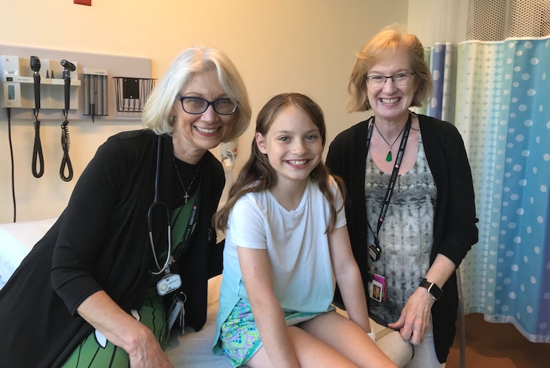 Oncology nurse Annette Wenger and oncologist Elizabeth Mullen with a patient with Wilms tumor