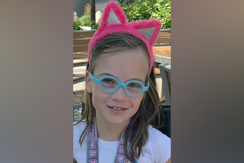 Scarlet, who had SDR surgery, wears a headband with pink cat ears