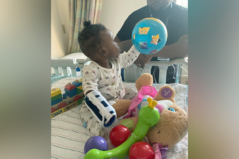 grace shows her dad a toy after surgery for a cloacal anomaly