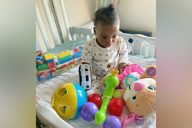 Grace plays with her toys. She was born with a cloacal anomaly.