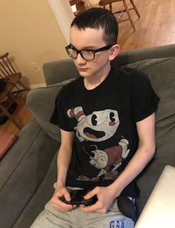 Jesse plays a video game during his vacuum bell therapy to correct pectus excavatum. 