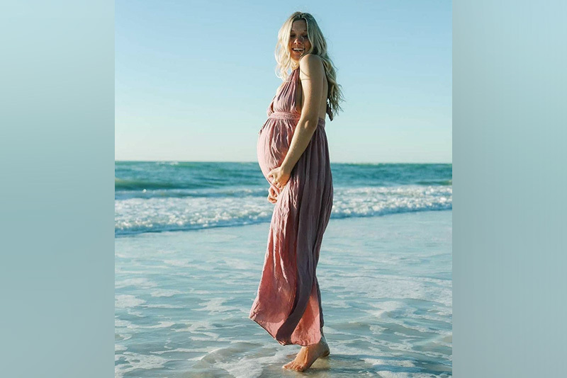 a photo of Jada on the beach. she is pregnant.