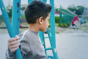 sad boy - concept of losing a parent to COVID-19